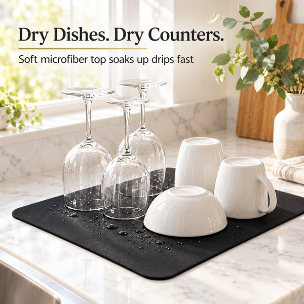 Black dish drying mat on a marble kitchen counter with glasses, mugs and a bowl drying on it