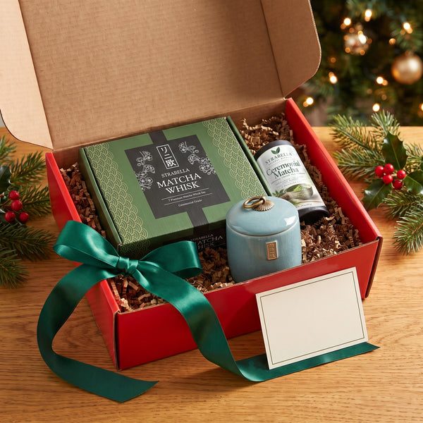 Open red Christmas gift box with the Strabella 7-piece matcha whisk set, Asanagi ceremonial matcha tin, Ru Kiln tea caddy (Blue set shown) and a note card