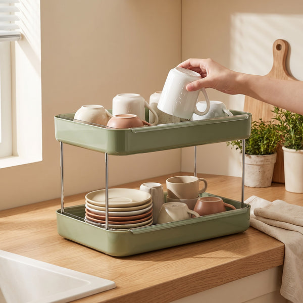 Countertop mug rack in use — hand setting a rinsed mug upside down to drain on the top tier