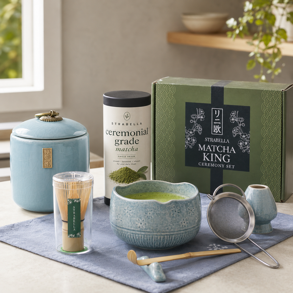 Matcha King set styled on a counter — blue crackle bowl with whisked matcha, ceremonial matcha tin and gift box