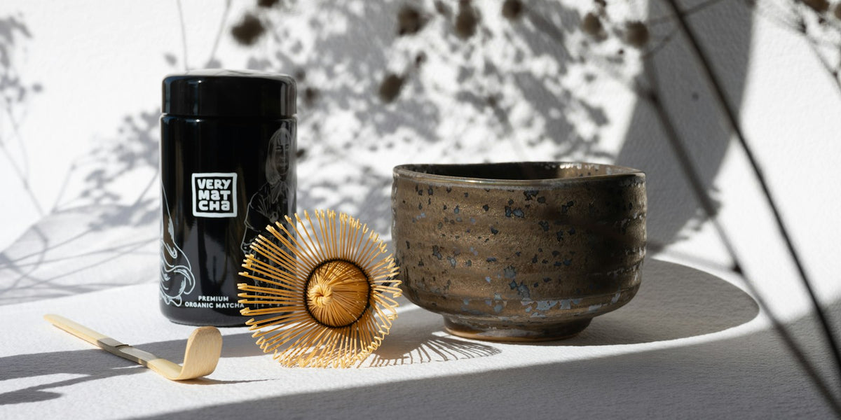 Matcha tea set — bamboo whisk, ceramic bowl, and matcha tin laid out for gifting