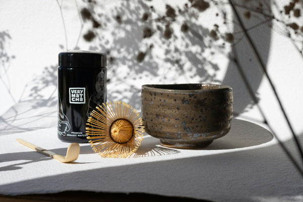 Matcha tea set — bamboo whisk, ceramic bowl, and matcha tin laid out for gifting
