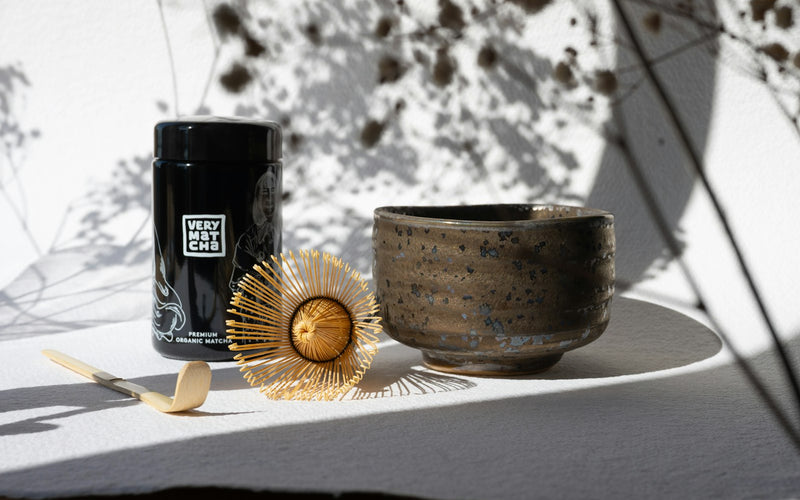 Matcha tea set — bamboo whisk, ceramic bowl, and matcha tin laid out for gifting