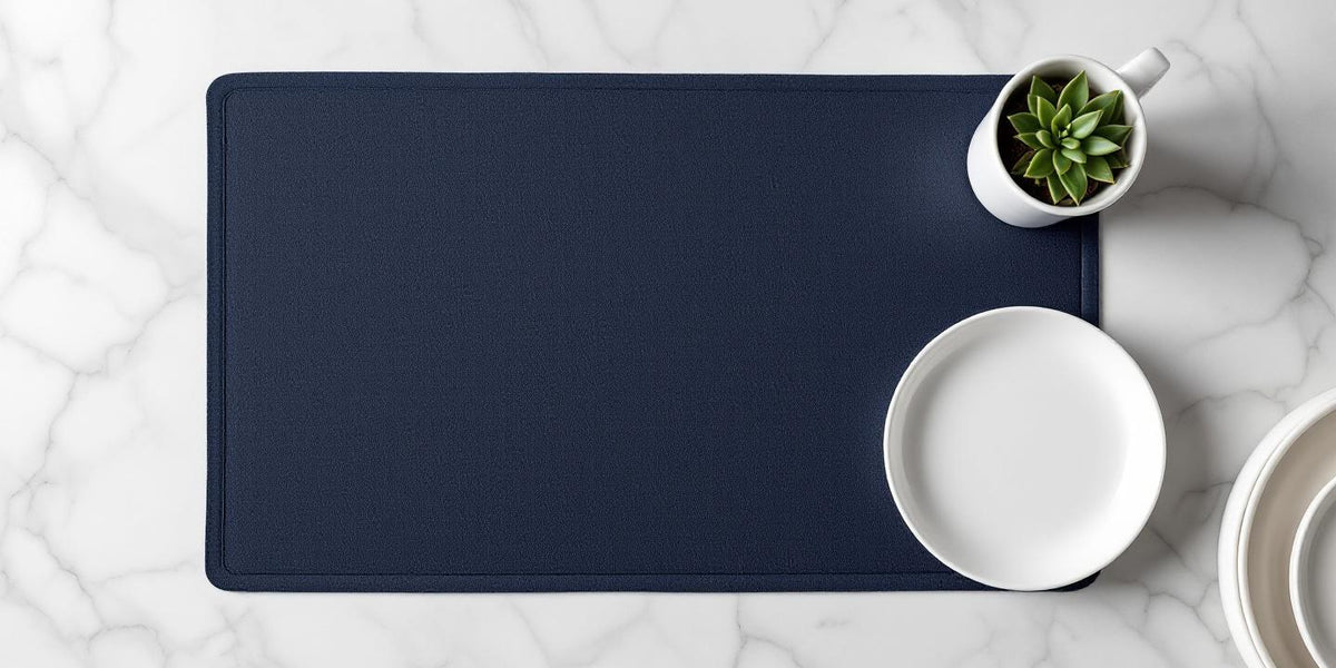 Eco friendly dish drying mat in navy blue on a clean marble kitchen counter