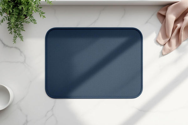 Eco friendly dish drying mat in navy blue on a marble kitchen counter, minimal setup