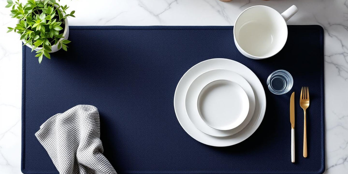 Eco friendly dish drying mat in navy blue on marble kitchen counter with ceramic dishes