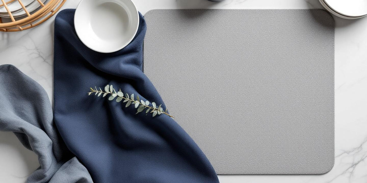 Eco friendly dish drying mat flat lay with stone mat and navy fabric mat on marble surface