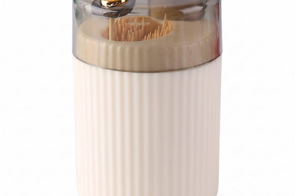 Pop-up toothpick holder in cream with one toothpick raised