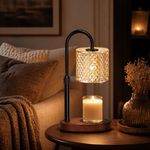 Crystal candle warmer lamp on living room side table with throw blanket and dried flowers