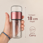 Hand holding the compact 18 cm double-wall glass tea tumbler, easy to carry