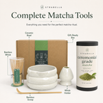 Complete matcha tool set with the white ceramic chawan, bamboo whisk, whisk holder and bamboo scoop