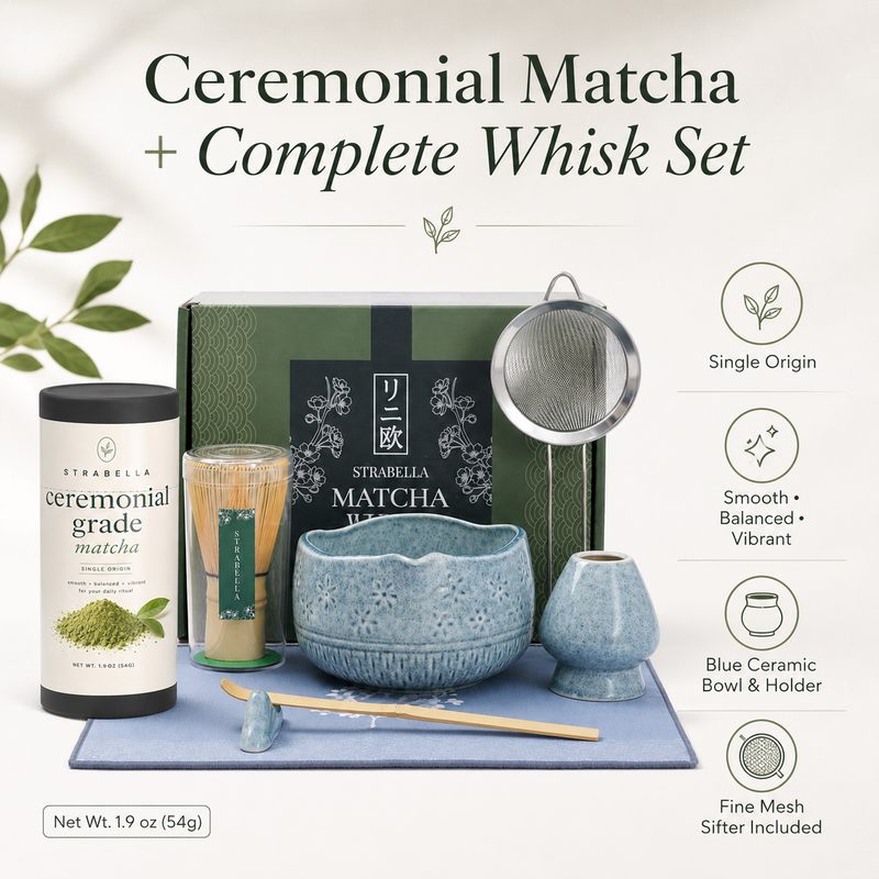 Bamboo matcha whisk on ceramic holder beside Strabella ceremonial matcha tin and blue bowl