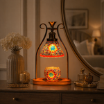 Orange mosaic candle warmer lamp on bedroom nightstand at dusk — warm glow ambience