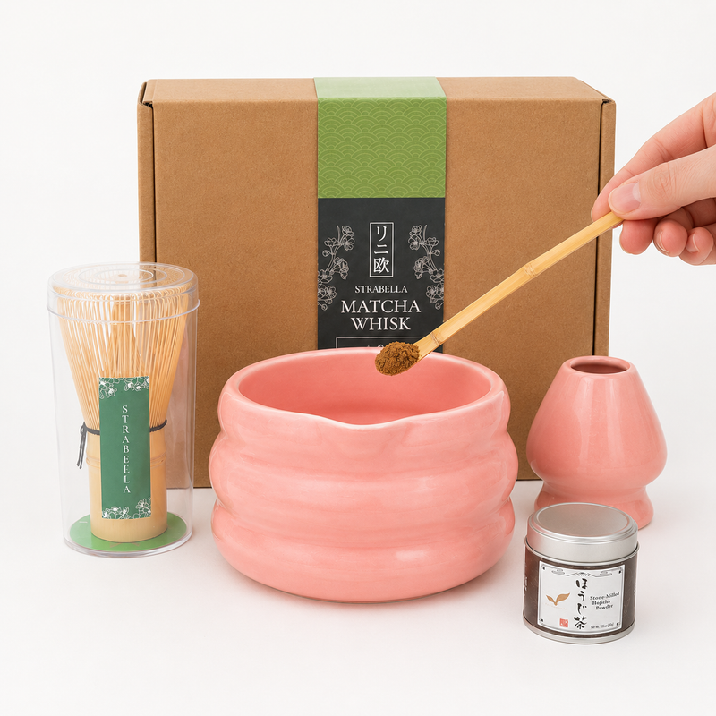 Whisking hojicha in the pink ceramic bowl of the Strabella Hojicha Set, with bamboo whisk and Kyoto hojicha powder