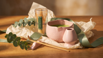 Pink matcha whisk set arranged as a gift with sage ribbon and eucalyptus