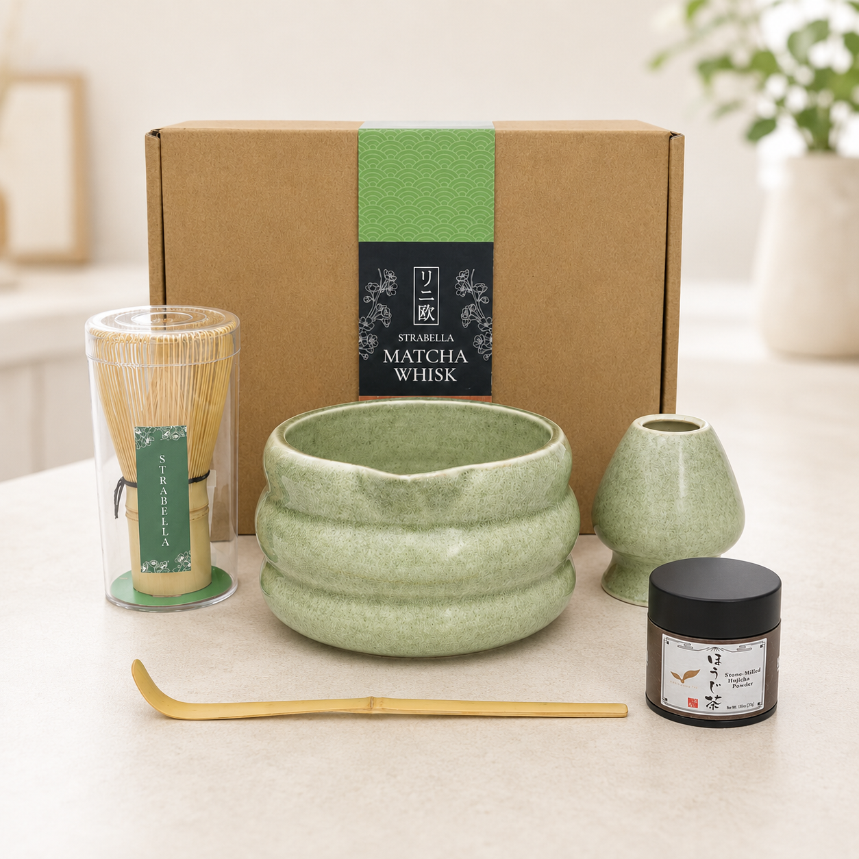 Sage green hojicha set styled on a kitchen counter — ceramic bowl, bamboo whisk and Kyoto hojicha powder