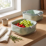 plastic colander with bowl on a kitchen counter with grapes and tomatoes