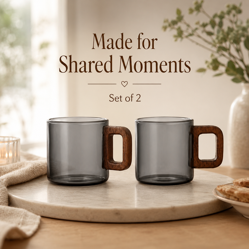 Two Strabella smoke-gray glass coffee mugs with wood handles on a marble tray, set of 2