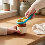 Jar opener — hands loosening a tight jam jar lid with the blue opener