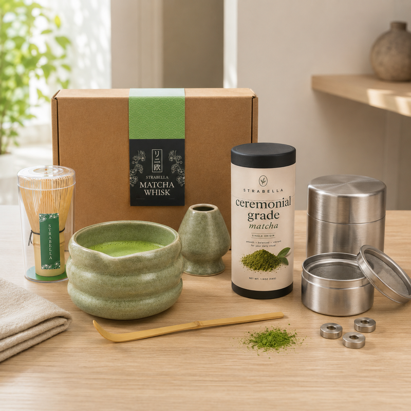 Strabella matcha starter kit arranged on a kitchen counter with whisk, bowl and ceremonial matcha