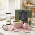 Pink Strabella matcha set on a marble kitchen counter with the gift box and ceremonial matcha tin