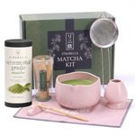 Pink matcha gift set — pink ceramic chawan, bamboo whisk, holder, sifter, ceremonial matcha tin and gift box on white