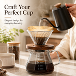 Pouring hot water into the Strabella glass pour-over coffee maker on a kitchen counter