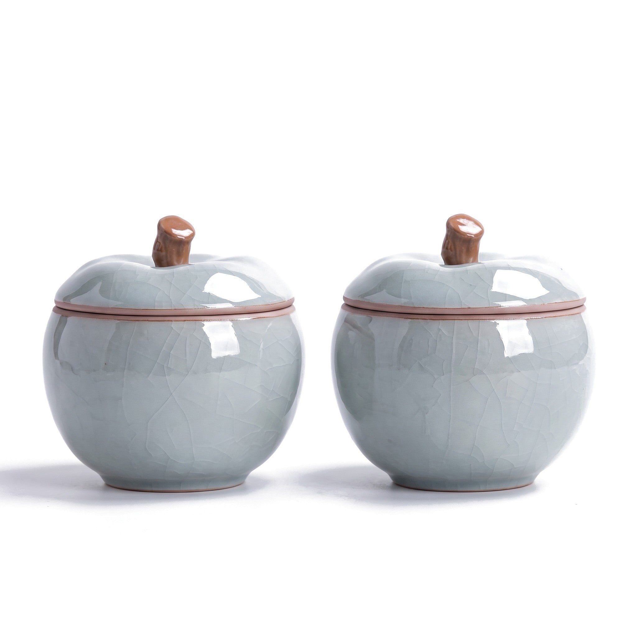 Trinket jar set of 2 — azure ceramic apple jars with stem-knob lids on white