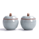 Trinket jar set of 2 — azure ceramic apple jars with stem-knob lids on white